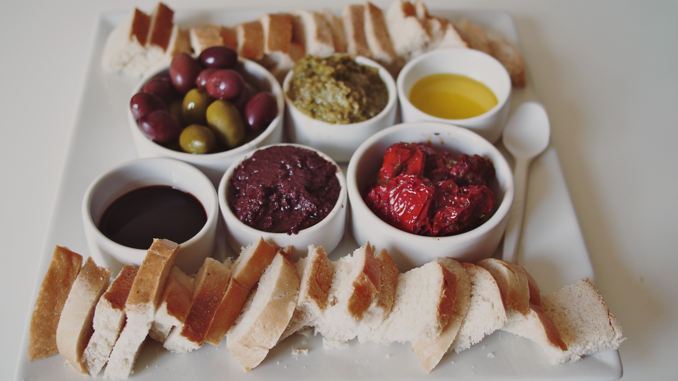 The tasting plate: bread, olive oil, balsamic vinegar, tapenades, olives and sun-dried tomatoes