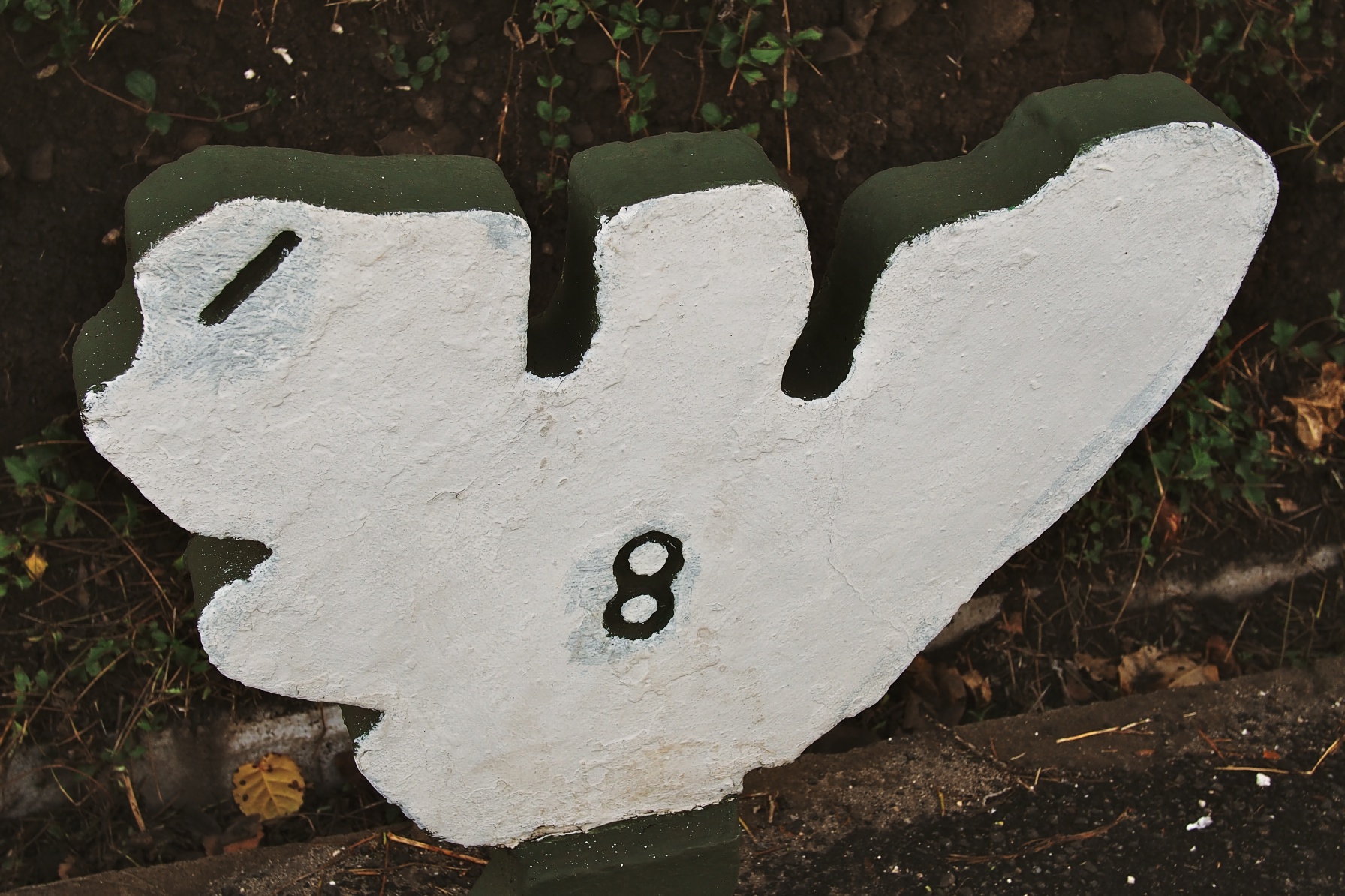 Posts, shaped like the island, signal distances along the single road encircling Mo'orea