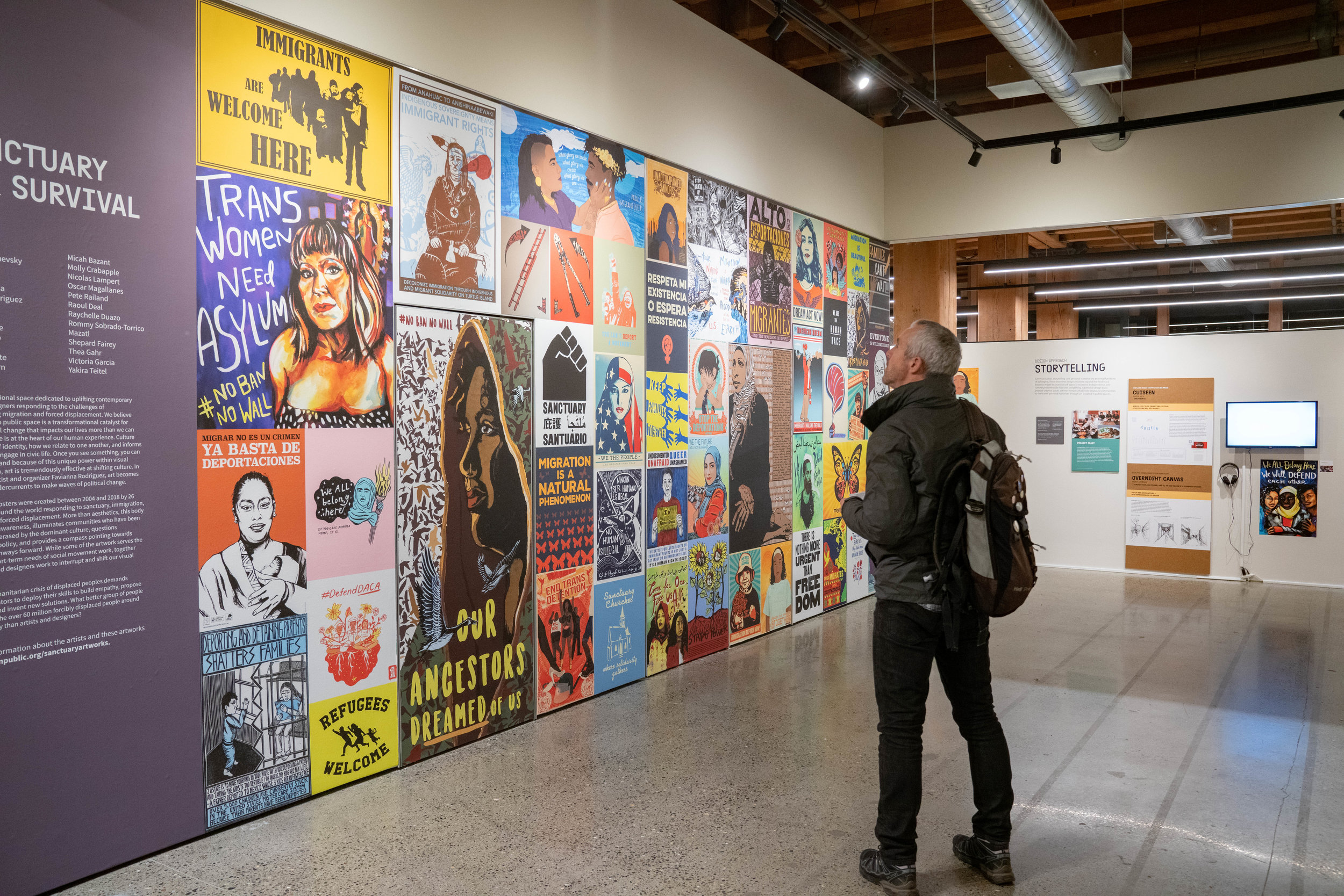 Highly visible from the street, a mural of posters selections from Amplifier archives showcases community responses to the need for sanctuary, safety, and belonging.