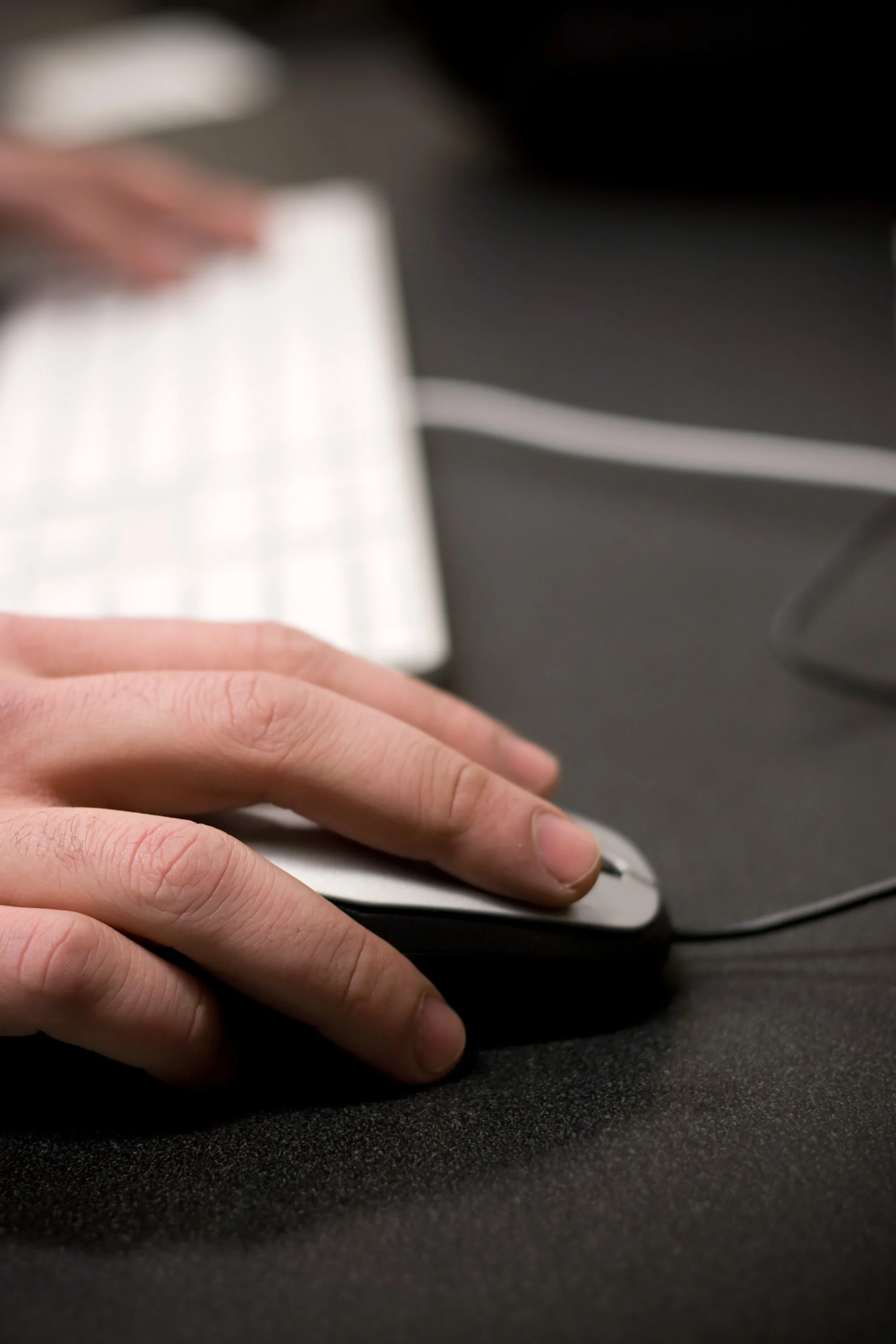 closeup-of-a-mans-hands-using-a-mouse-and-computer-keyboard-while-gaming-or-surfing-the-world-wide-web-shallow-depth-of-field_rKNVsPABs.jpg