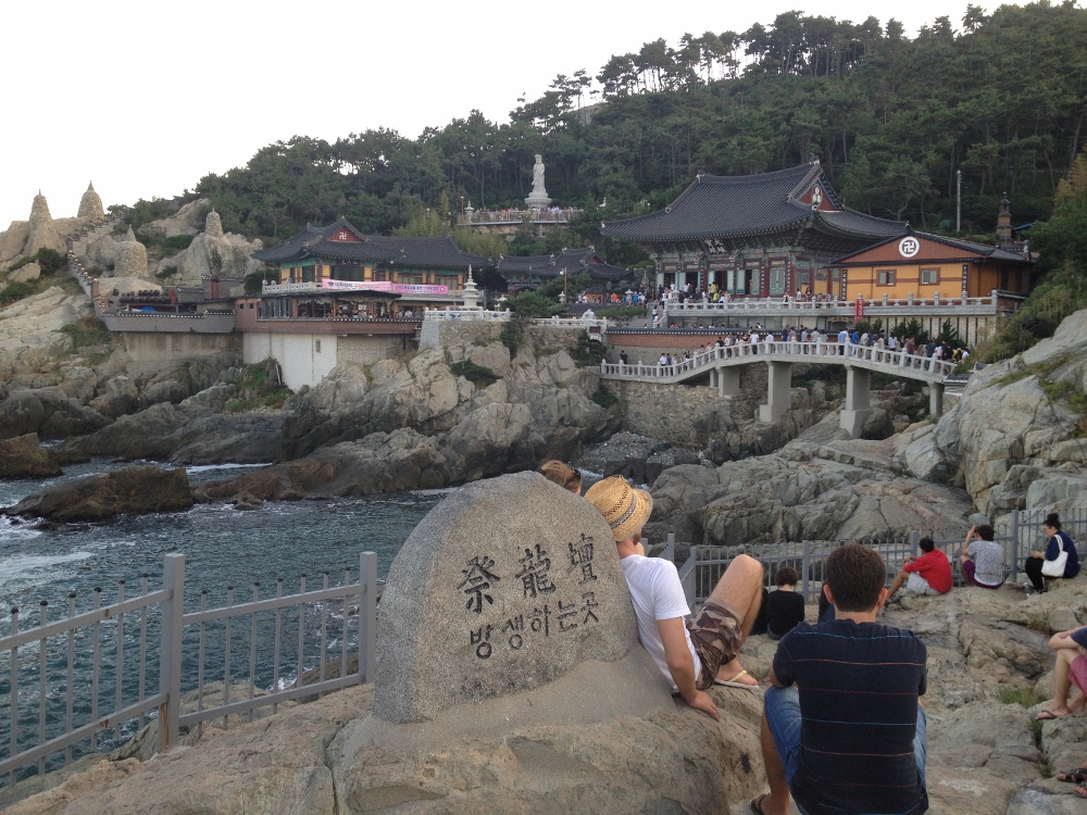  People chilling on rocks enjoying the temple view 