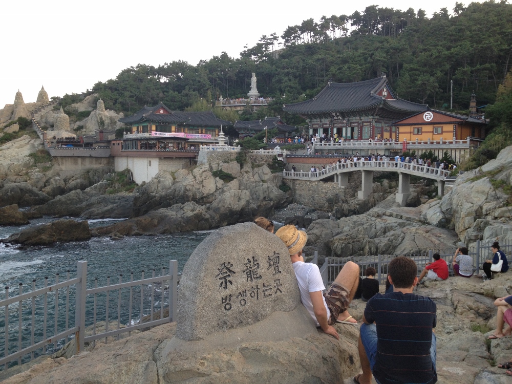 People chilling on rocks enjoying the temple view