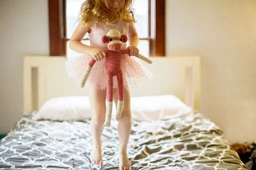 little girl with otis in bedroom .jpeg
