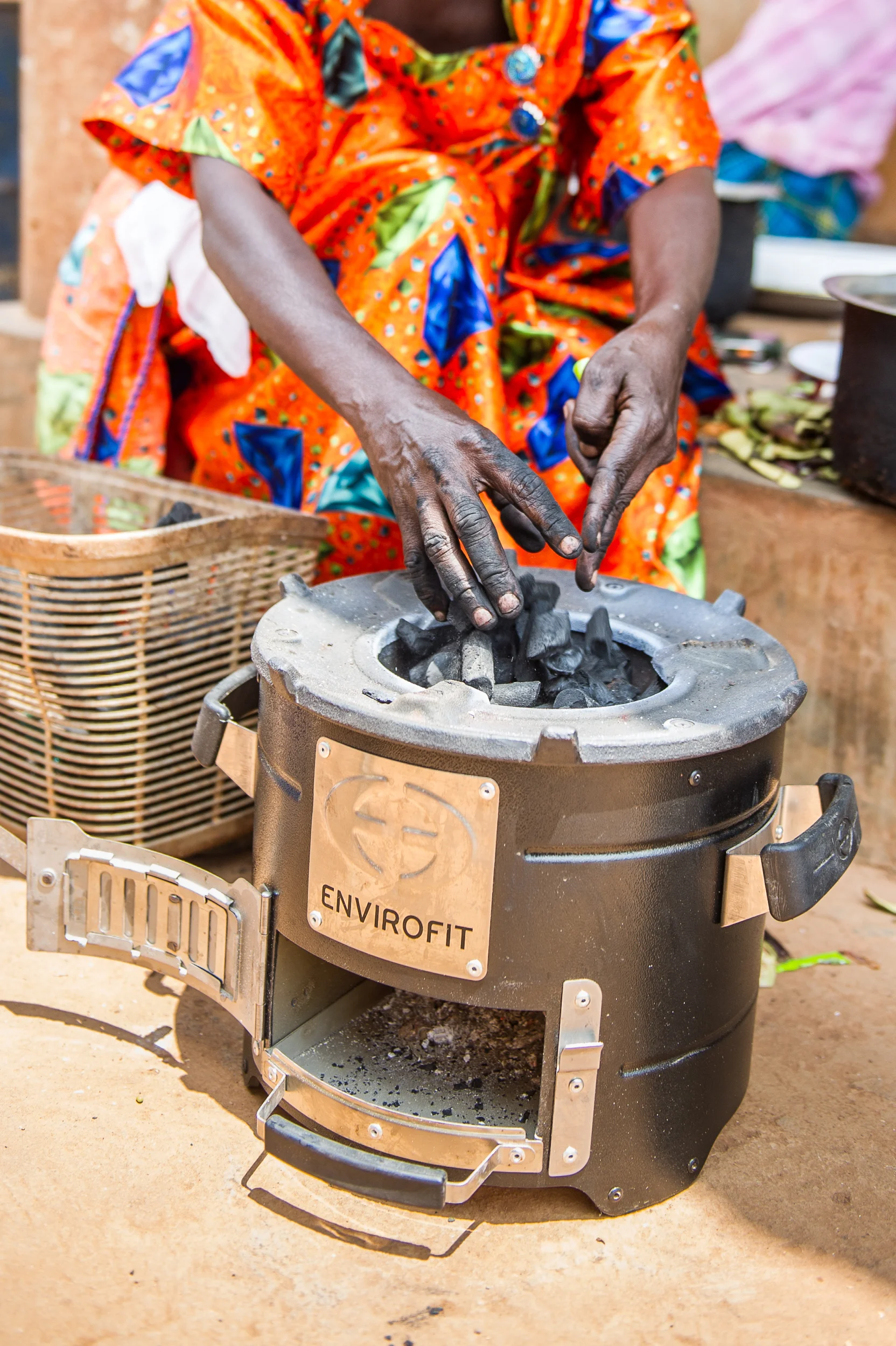 The clean cookstove uses a small amount of charcoal, cutting Jane's need for fuel by 70 percent.