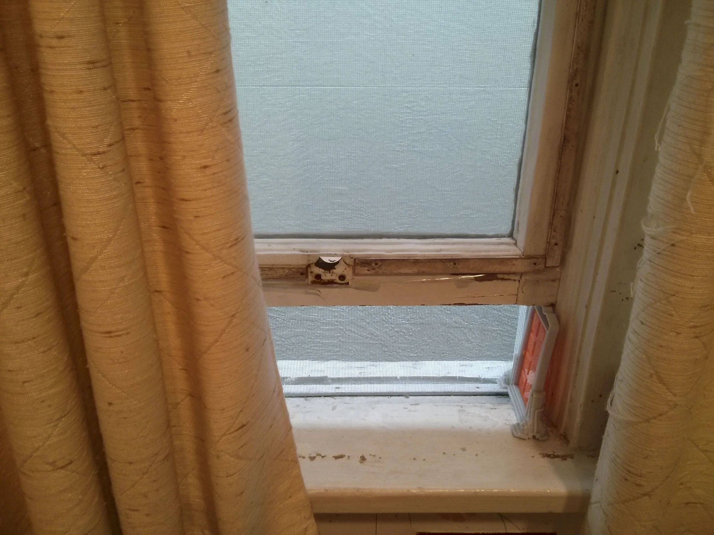 A McDonald's happy meal toy from Monster's Inc holds up the bathroom window