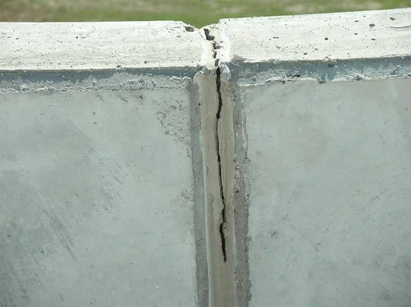 This happens quite often. When the sealant fails, water can enter the joint, run down behind the roof’s wall base flashing, and get into the roof system. Corrosion of metal deck and fasteners is a common result, as is insulation deterioration.