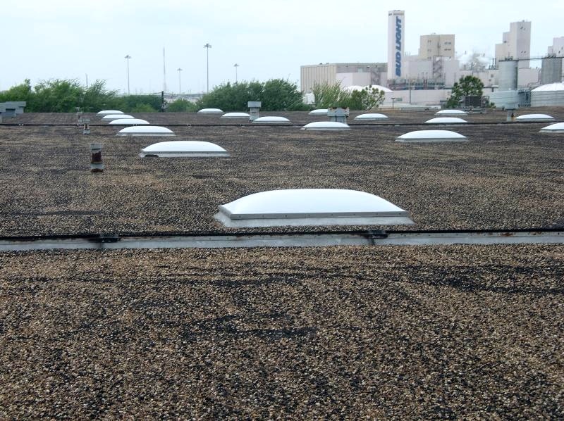 Over the years, heavier aggregates can sink slightly into the coal tar pitch flood coat, resulting in a relatively dark appearance. 