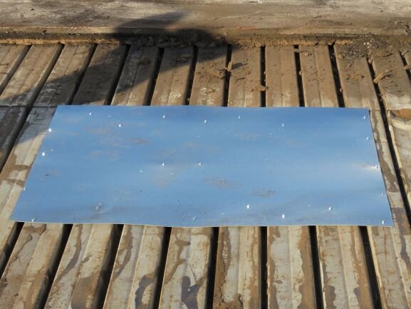 A piece of 24-gauge galvanized steel used to patch a rusted area of steel roof deck.