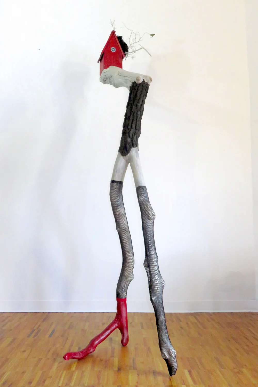 The Fascinator, 2015 Tree limbs, wood house, LED light, glass, bird’s nest, nylon stockings, acrylic paints, wood stain 96" x 30" x 32"