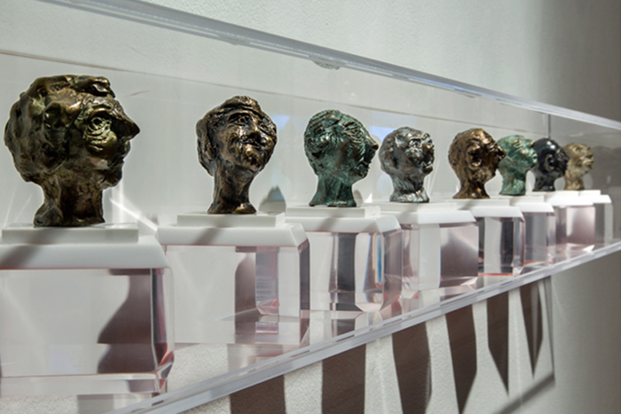   Counterpoise , 2015 8 bronze heads mounted in a plexiglass display 2” x 3“ 