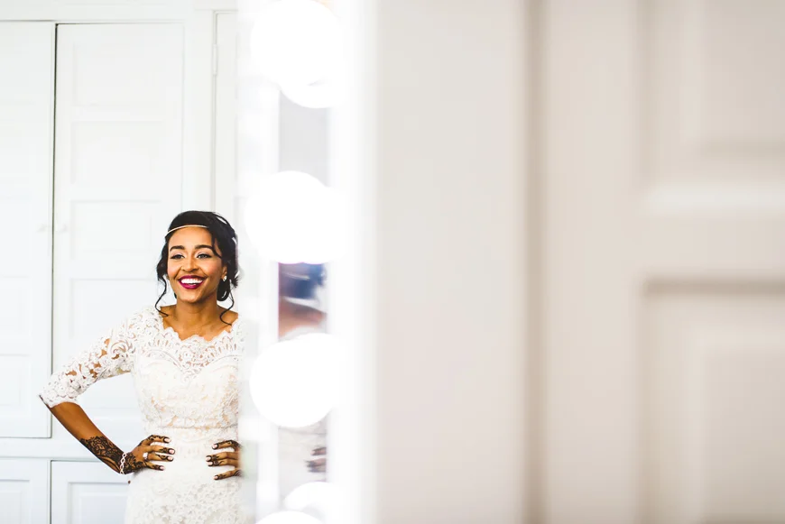 004 beautiful bride laughing in mirror.jpg