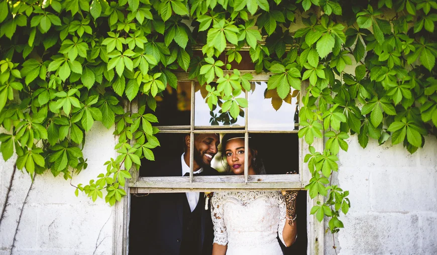 014 gorgeous bride looking out an old broken window.jpg