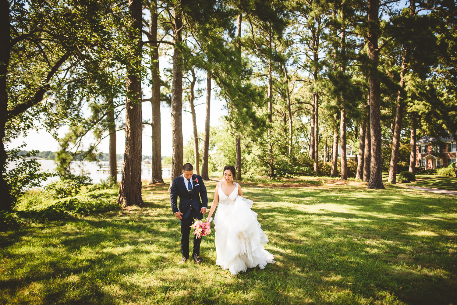 024 bride and groom walk among the trees after getting married.jpg