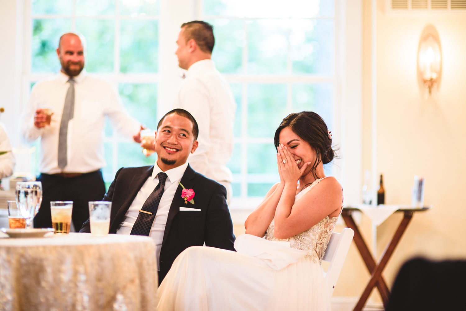 044 bride covers her face during toasts.jpg