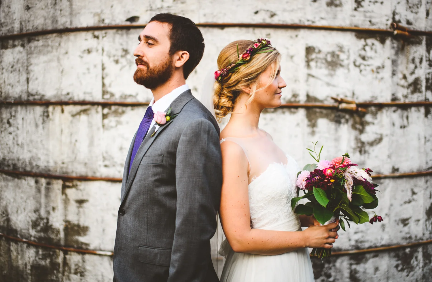 023 - creative portrait of bride and groom in front of barn silo.jpg