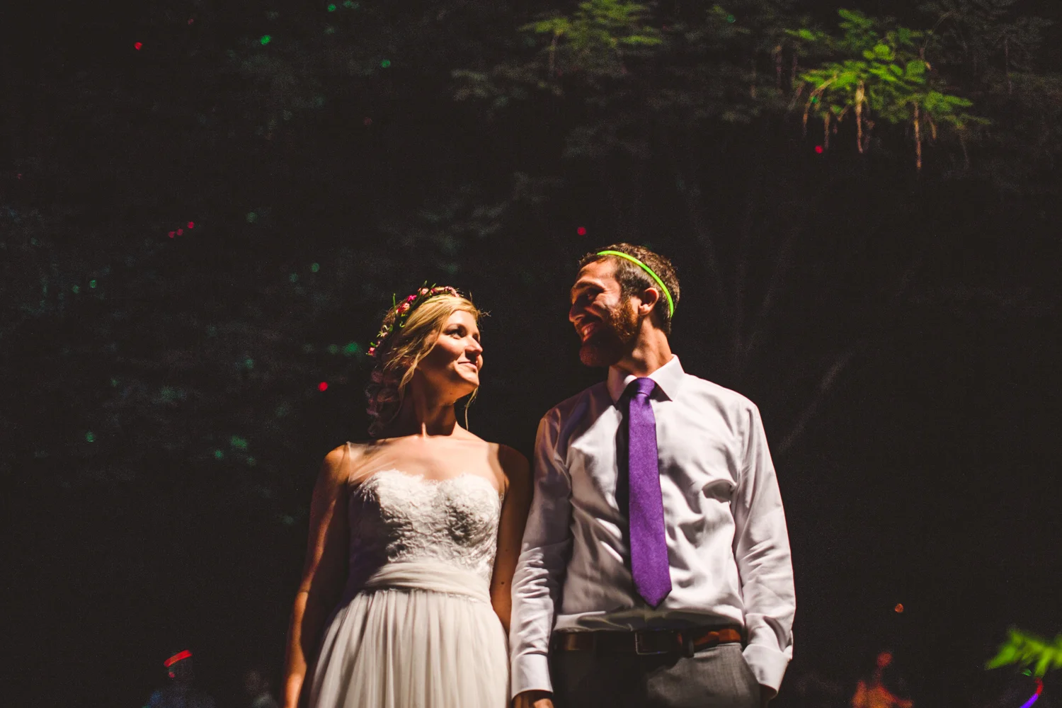 030a - night portrait of bride and groom in front of neon trees.jpg