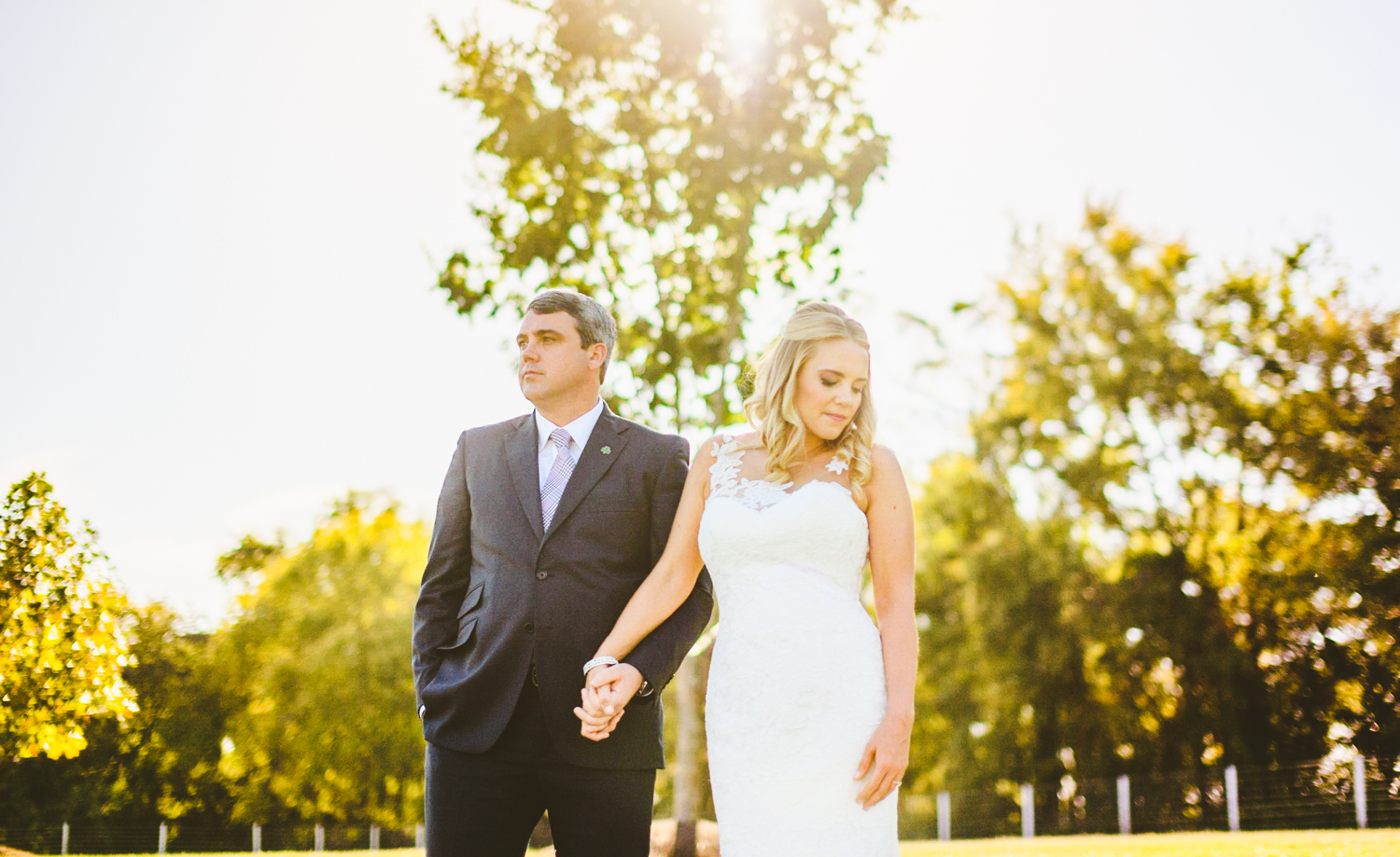 005 - backlit portrait of bride and groom in front of a small tree.jpg