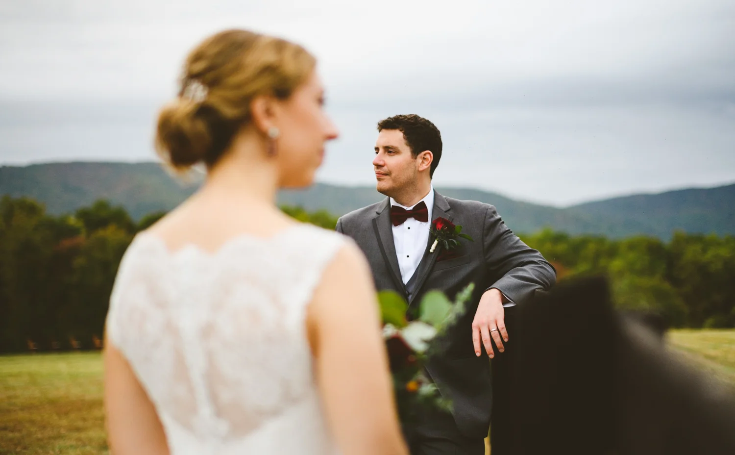 006 - wedding portrait focus on groom with bride out of focus in foreground.jpg