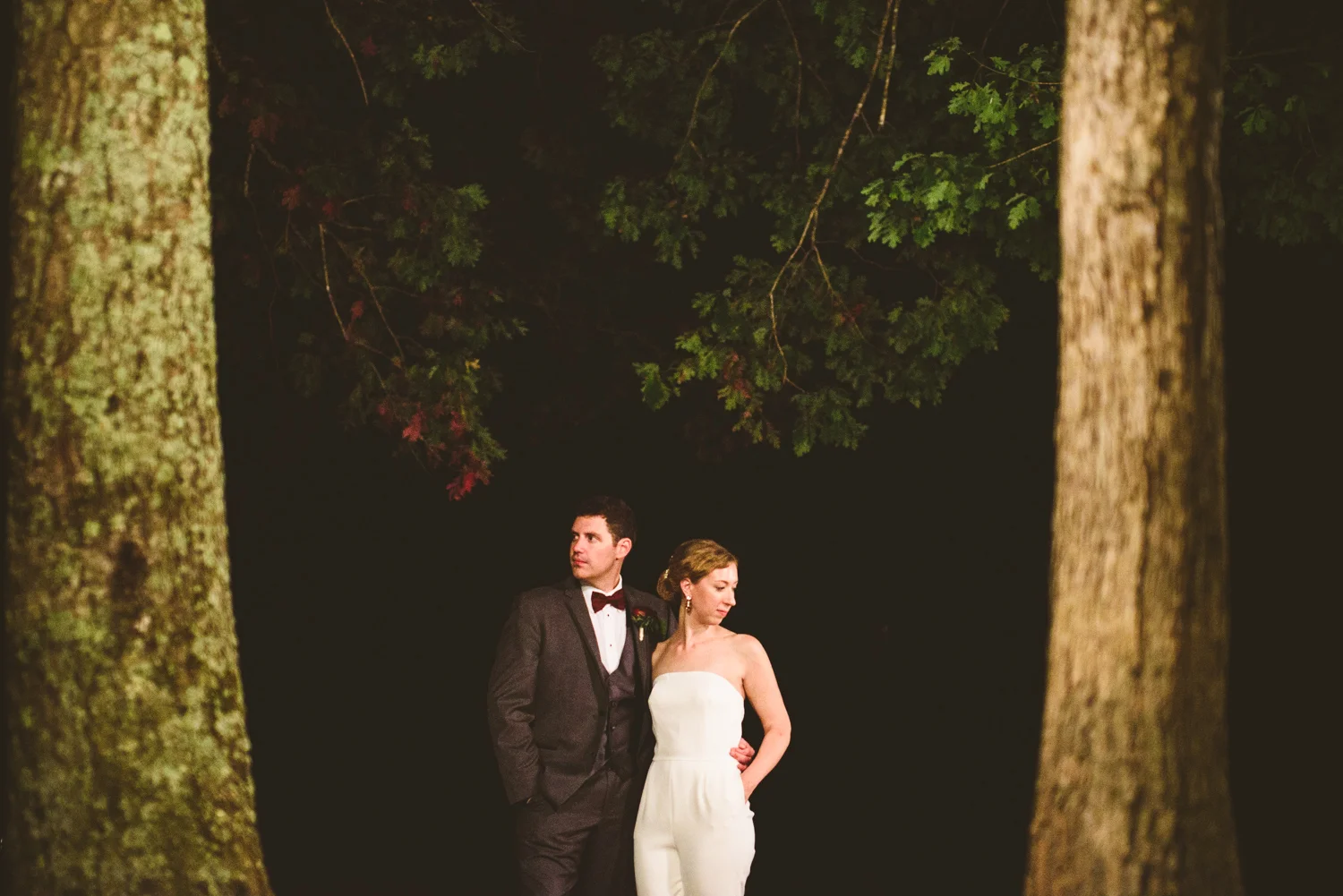 016 - bride in wedding jumpsuit poses for a night portrait in virginia forest.jpg