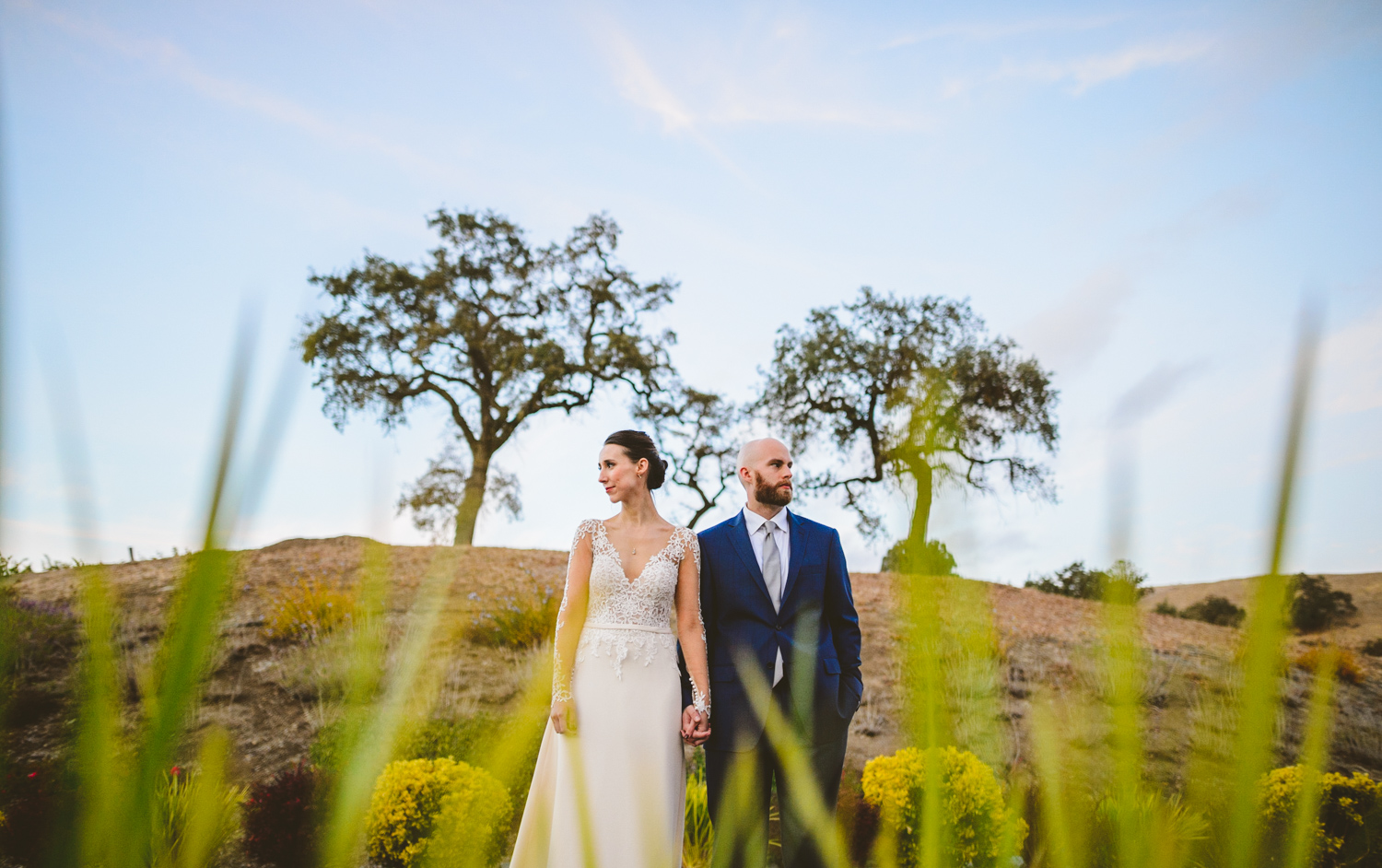 026 - creative portrait of bride and groom with california tree in the background.jpg