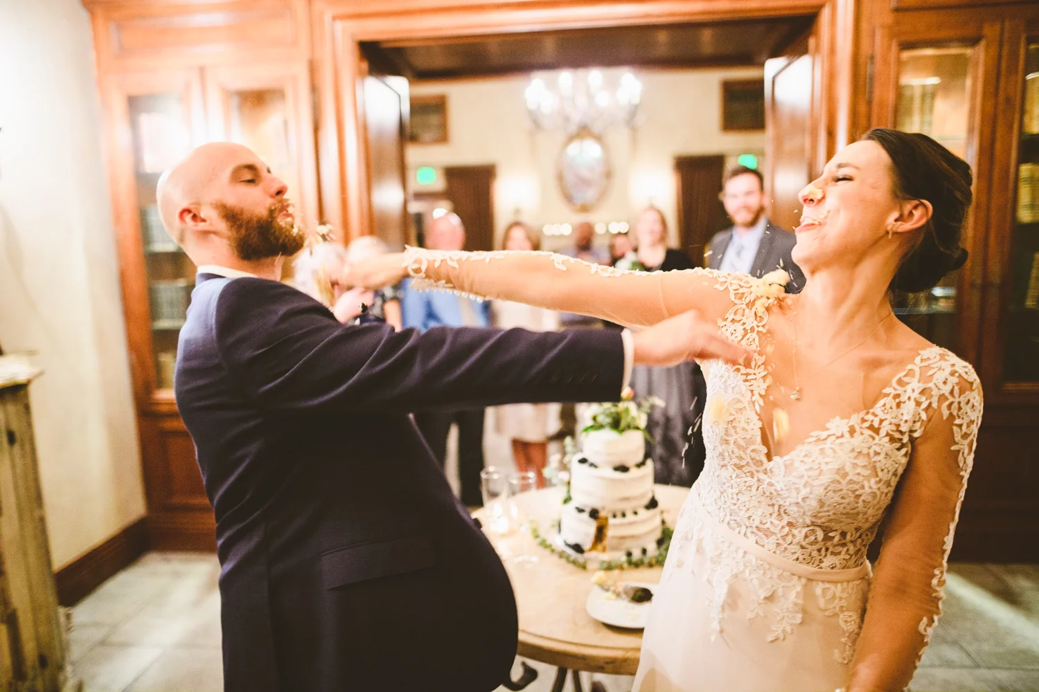 035 - bride and groom smash cake in each others faces.jpg