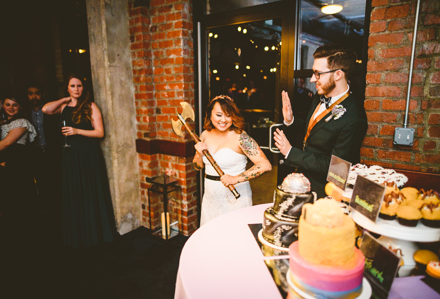 036 - bride prepares to cut the cake with a giant wedding axe.jpg