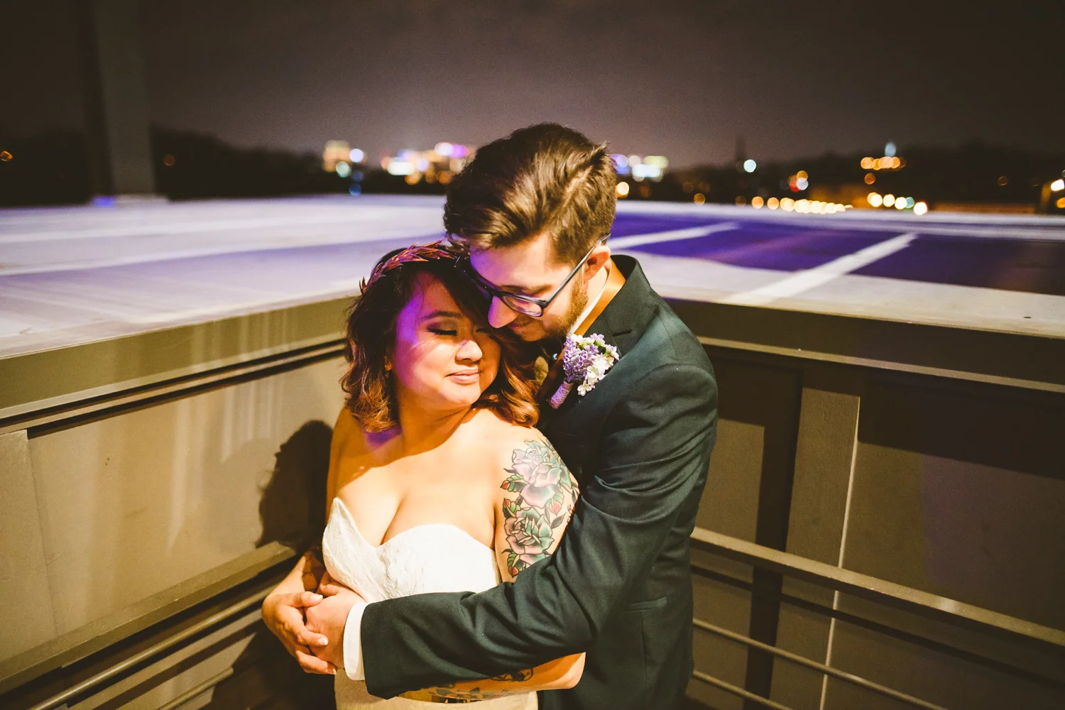 045 - bride and groom pose with night richmond background.jpg