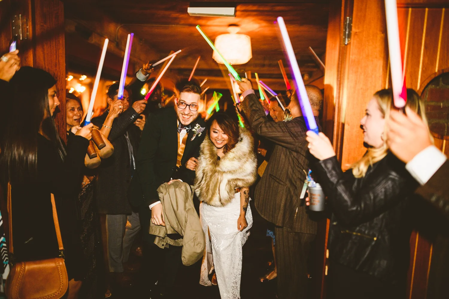 046 - bride and groom exit their wedding with lightsabers.jpg