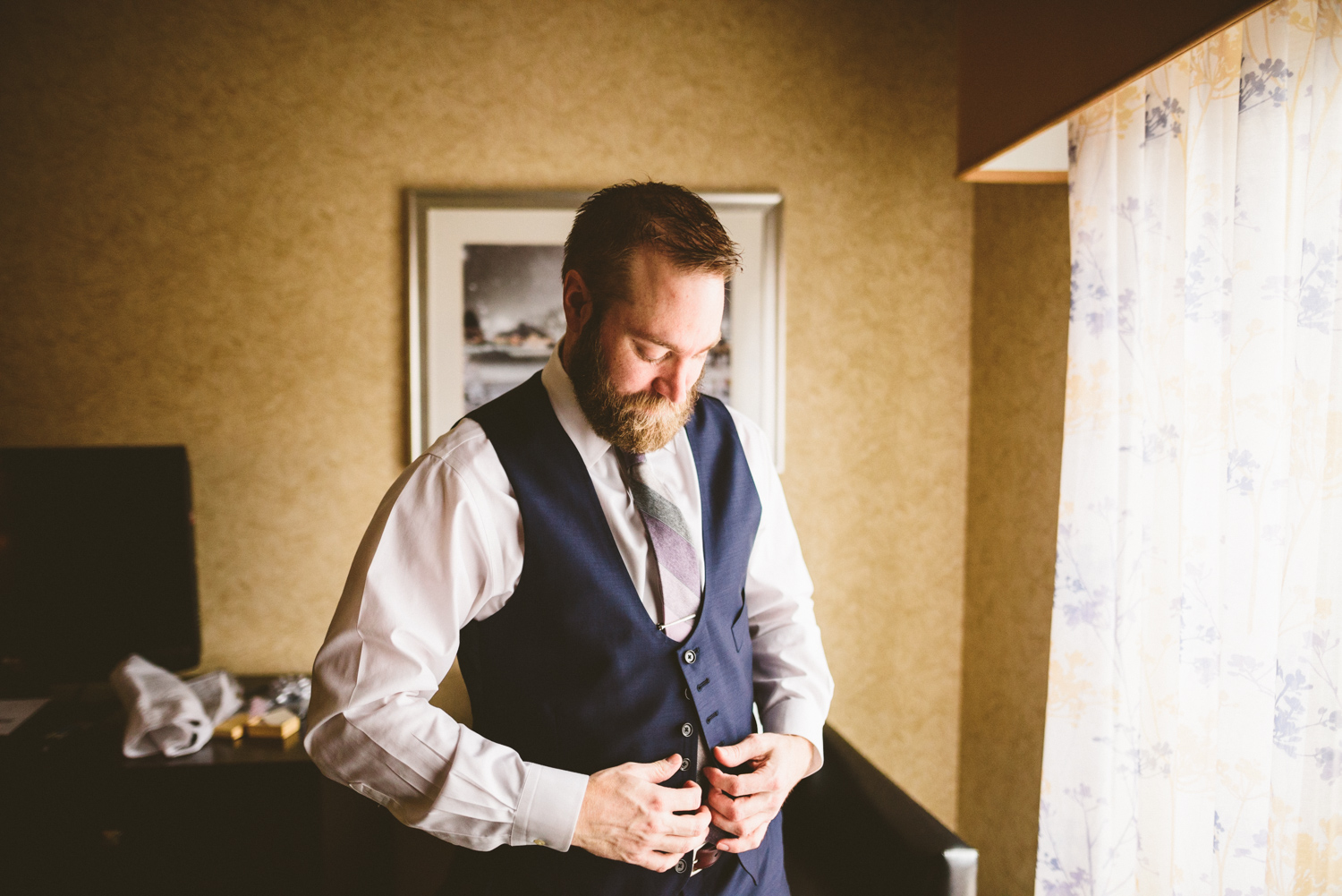 011 - groom puts on vest.jpg