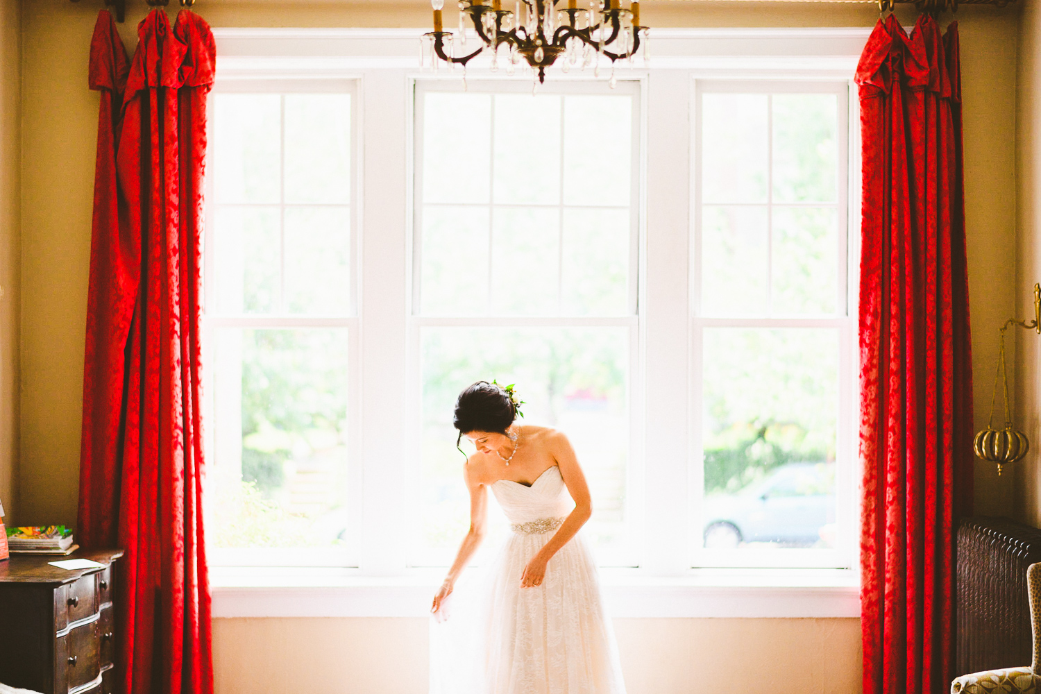 010 - portrait of the bride in front of window with beautiful red curtains.jpg