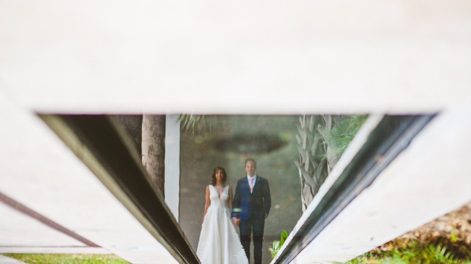 035 - creative portrait of bride and groom reflection in pool.jpg