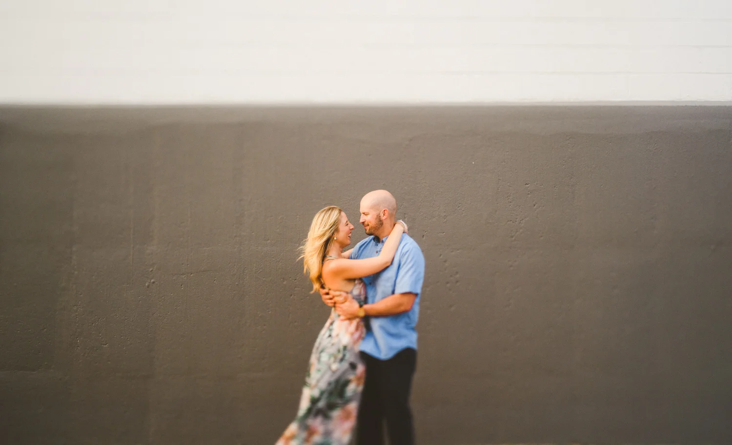 038 - freelens of couple dancing in front of grey and white wall.jpg