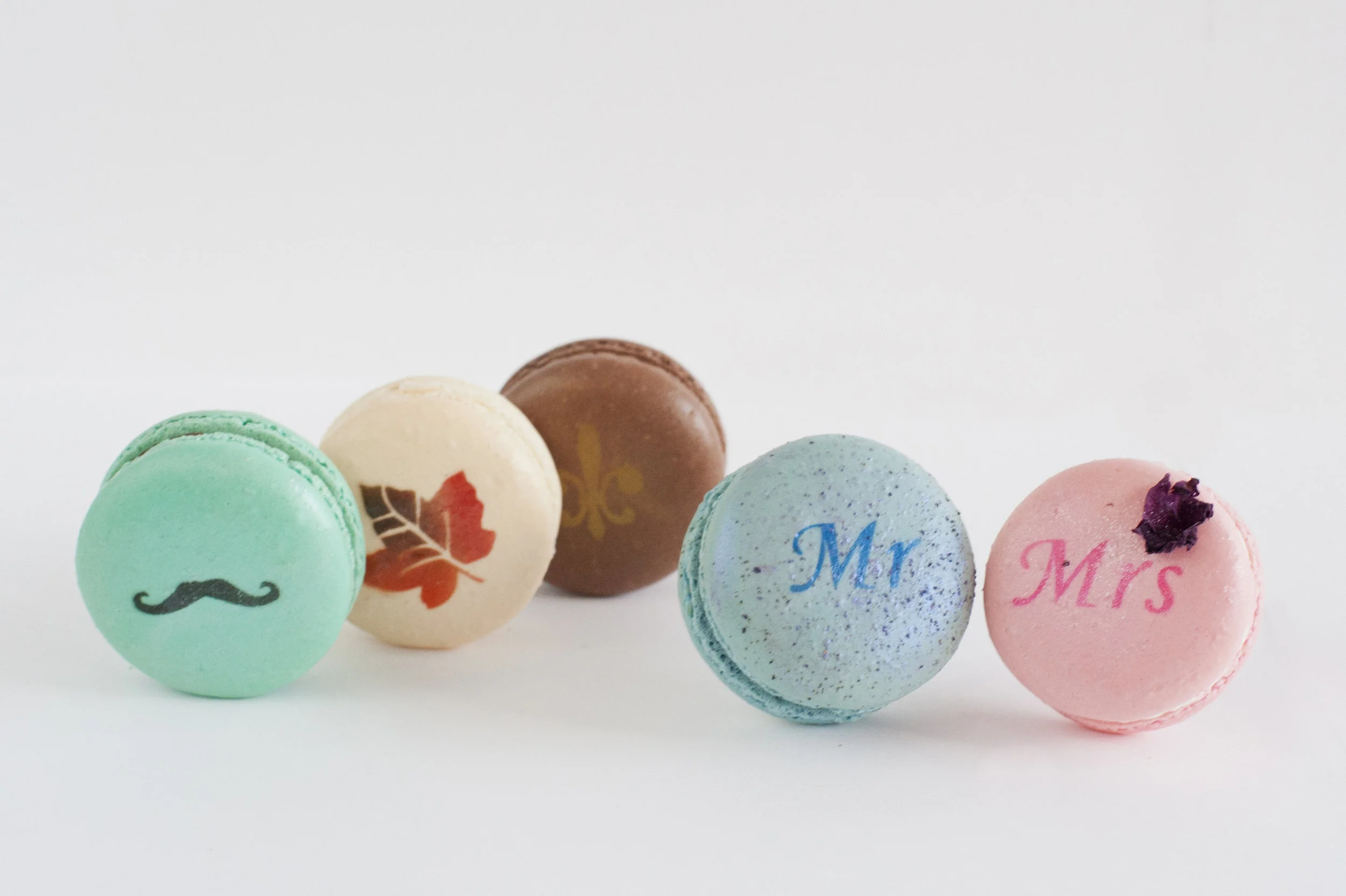 Logos, monograms, & other images can be airbrushed on to macarons