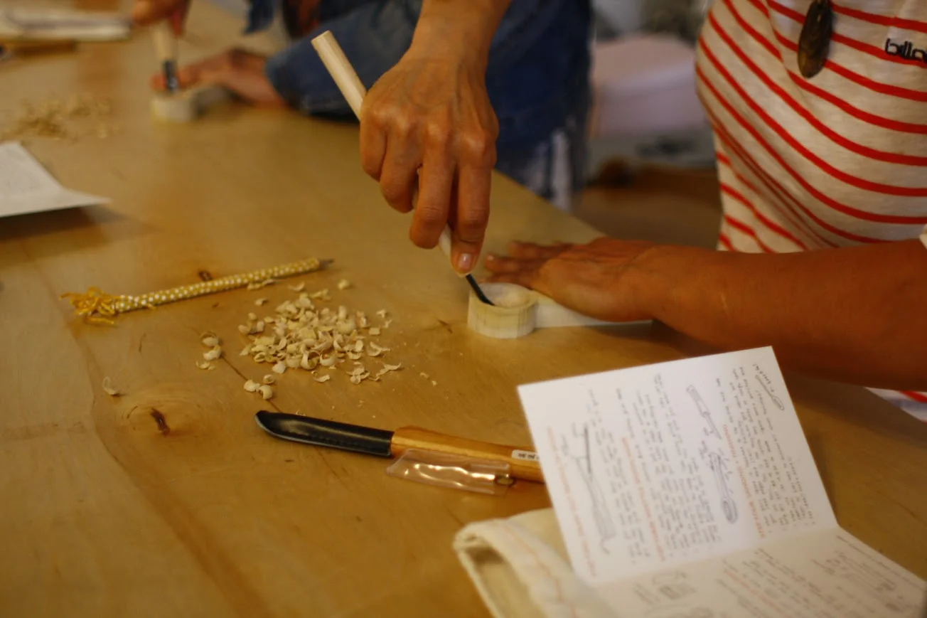 A student carving her spoon