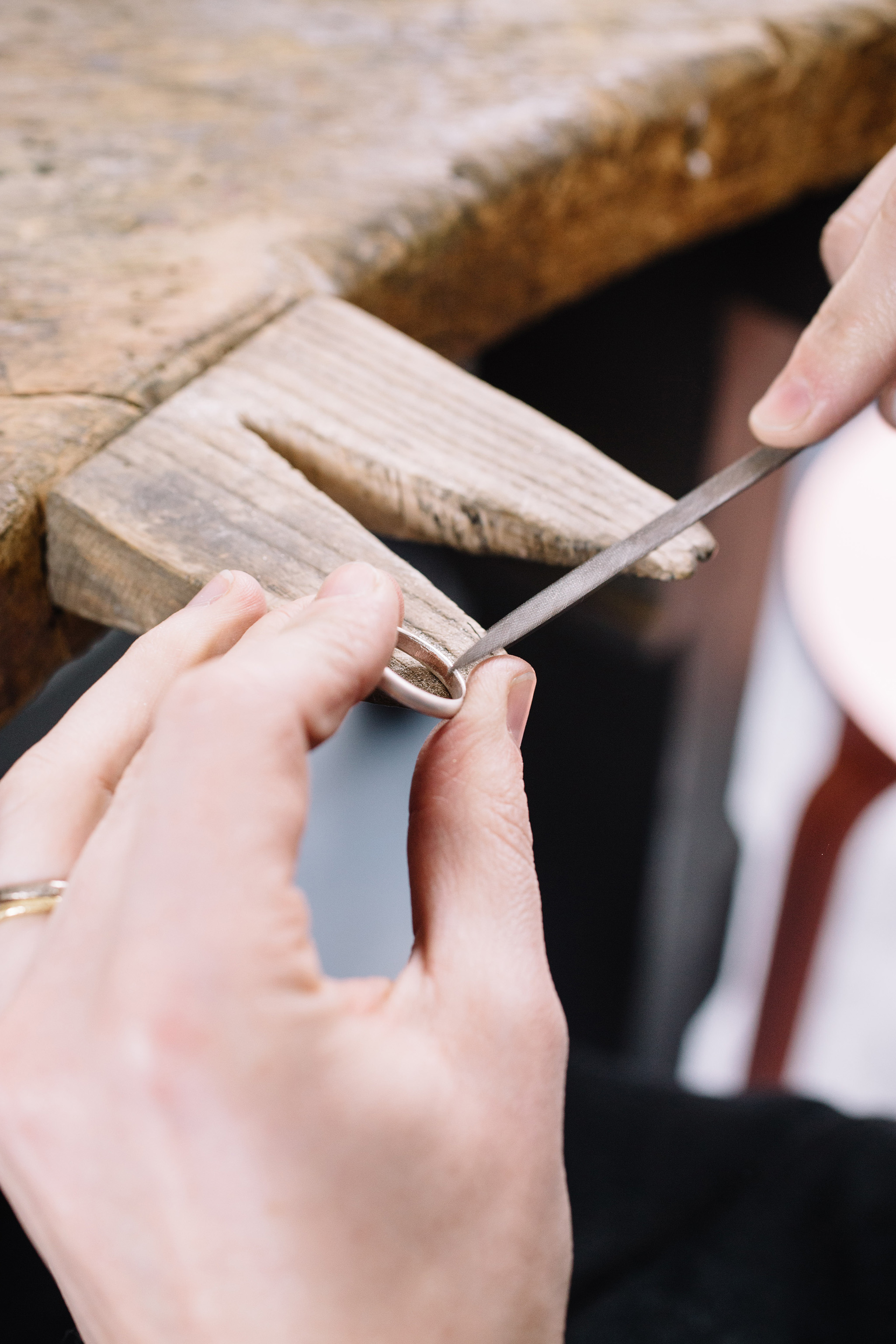 hand making a silver ring with file and benchpeg 