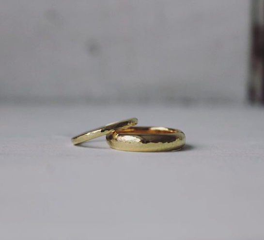 textured thin gold ring next to polished wide ring 