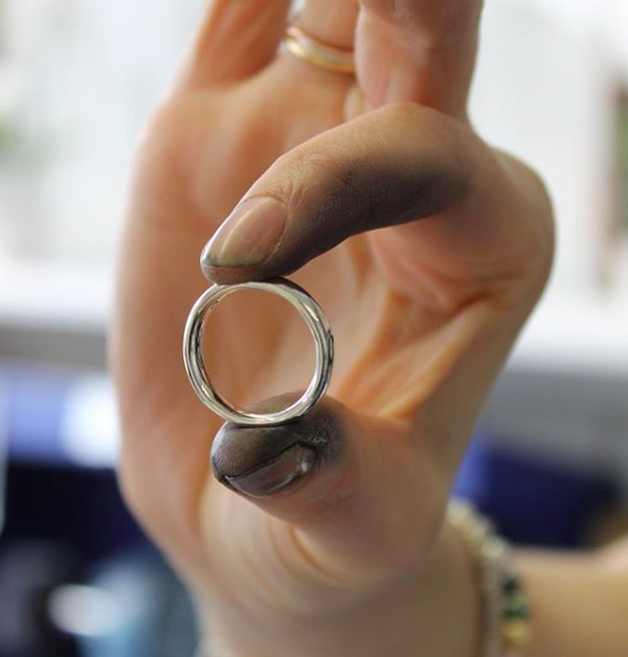 a finished polished wedding ring being held 