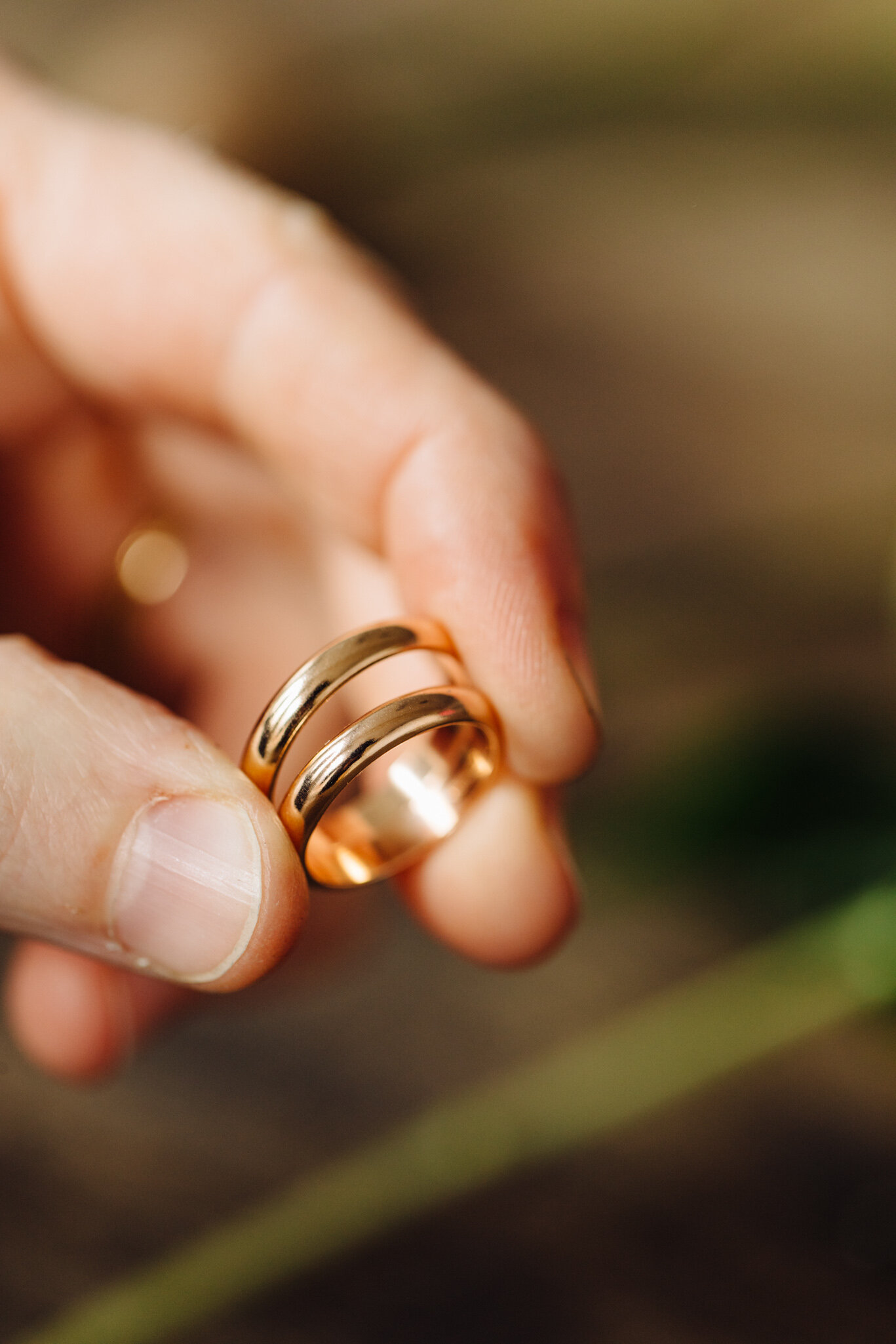 Yellow gold handmade wedding rings in the sunshine in our Jewellery Quarter workshop 