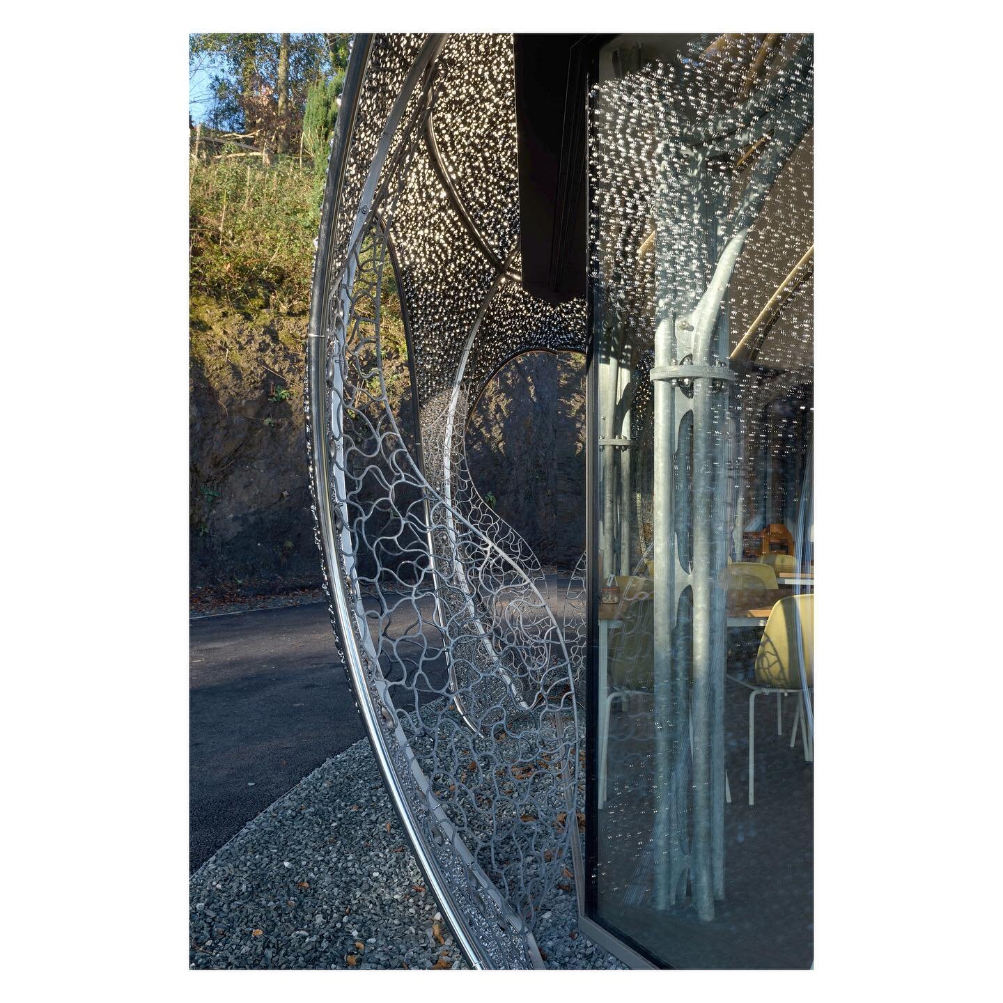 | Oriel Plas Glyn-y-Weddw

The outer shell of the new cafe at @orielplasglynyweddw is made of 89,000 individual stainless steel barnacles secured into welded sections which are supported off the weathertight structure below. This create a permeable l