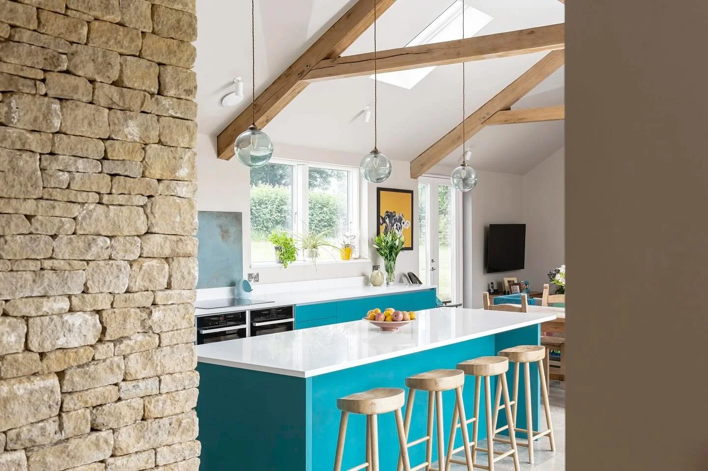 The single storey west wing of Field House in Wiltshire is a vaulted space with oak &lsquo;a&rsquo; frame trusses holding the natural slate roof. 

Internally, it houses the kitchen, breakfast space and a family snug, all kept warm with underfloor he