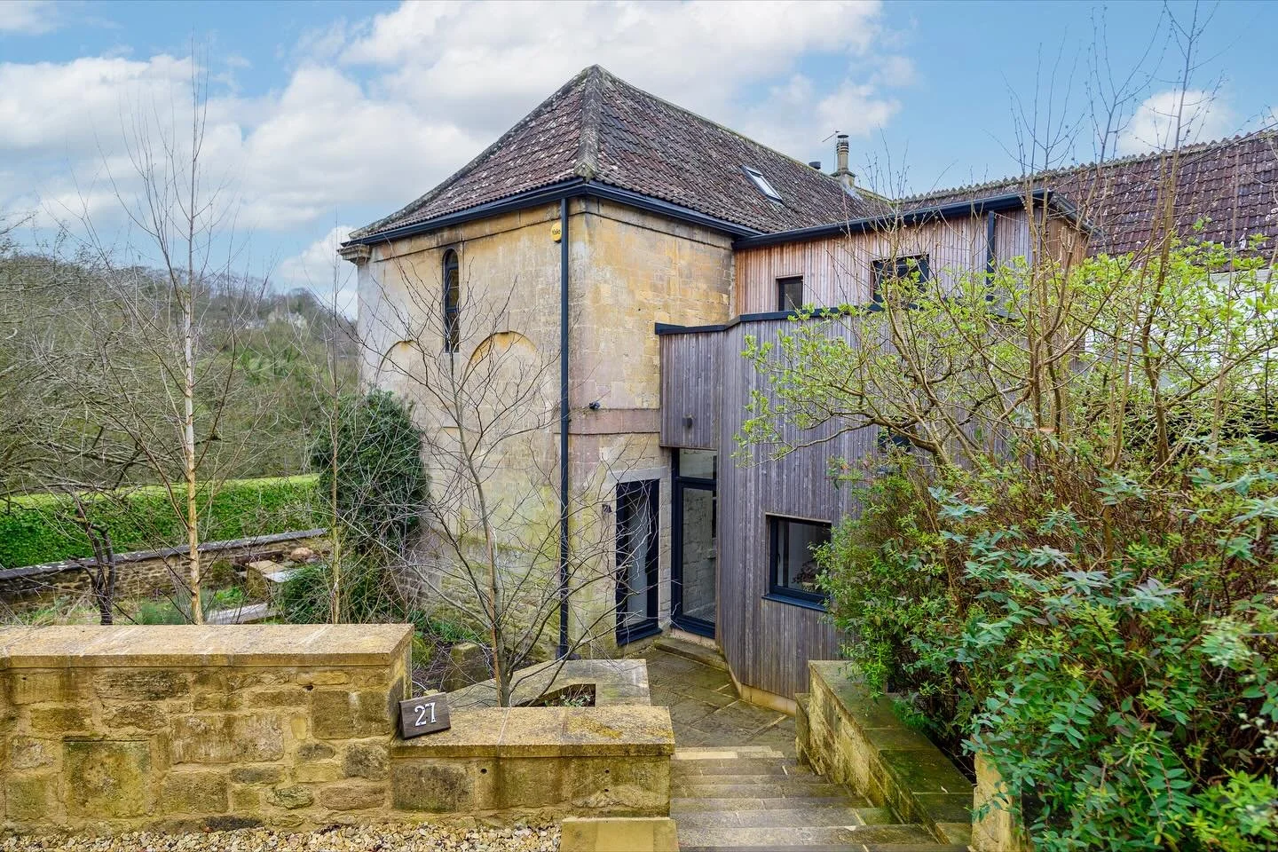 The reimagining of a former coach house in Wiltshire. 

Drawing light and landscape into the heart of the home, part of the works included the dropping of the ground floor windows to create french doors opening out  onto a new east facing balcony, pr