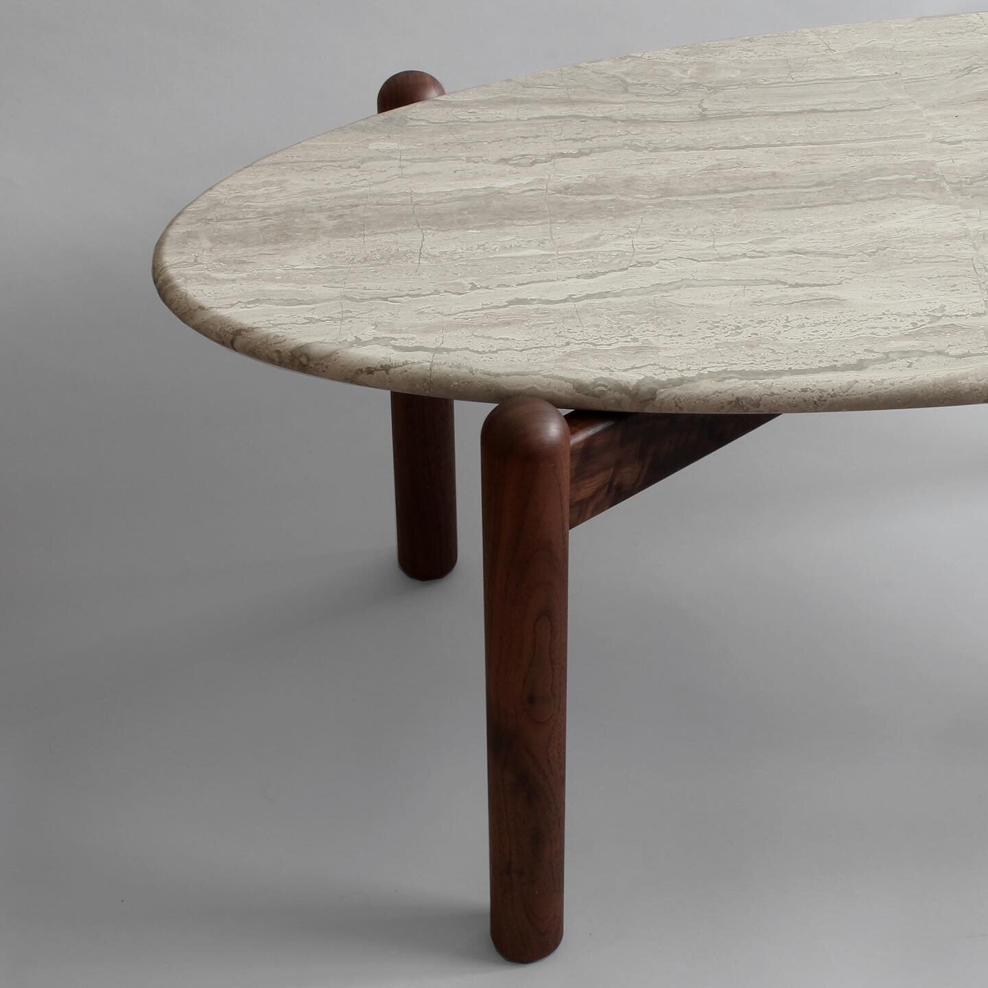 Custom Ellipse coffee table for @leonoramahle in silver travertine and black walnut