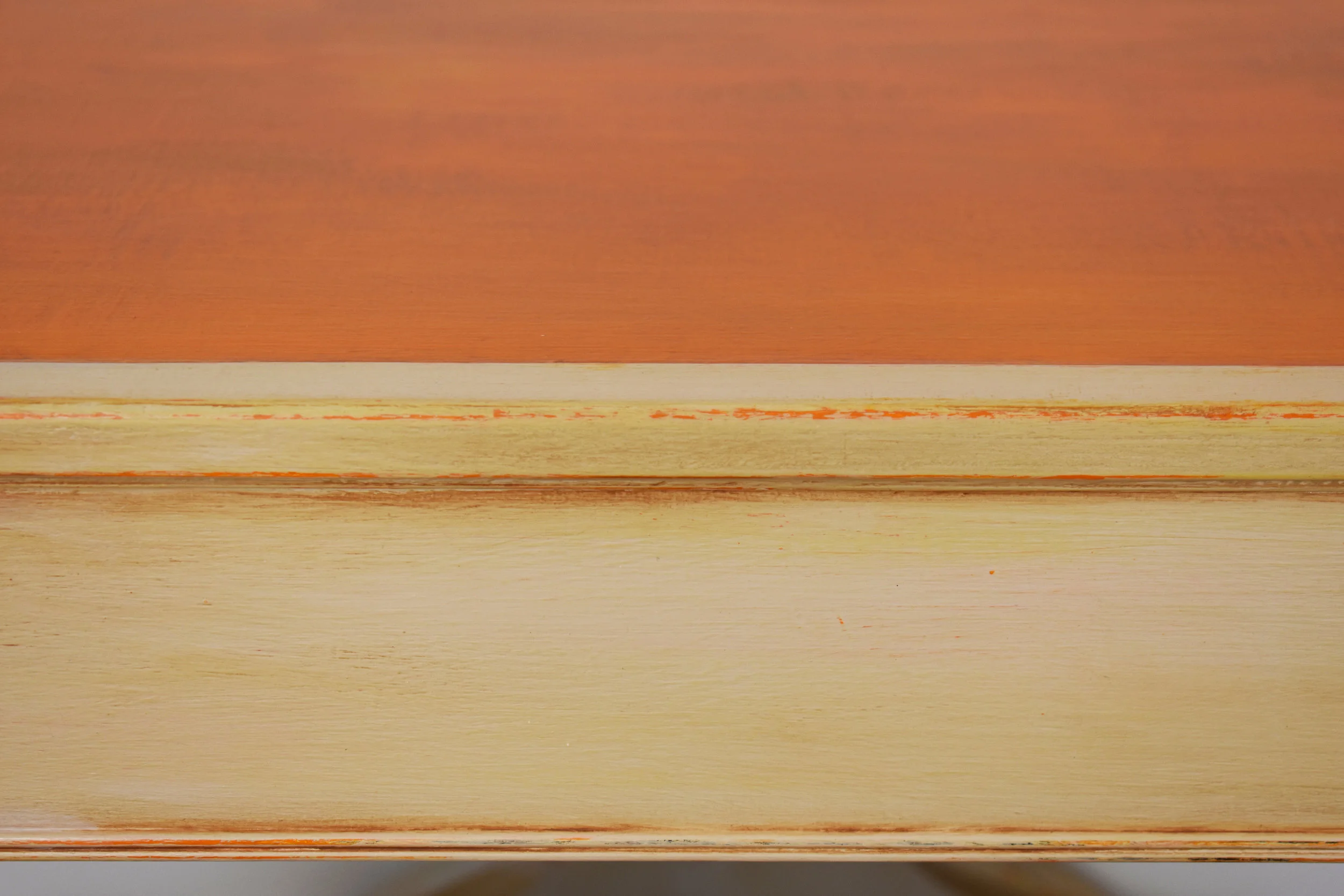 Off-white paint finish, distressing shows orange peeking through