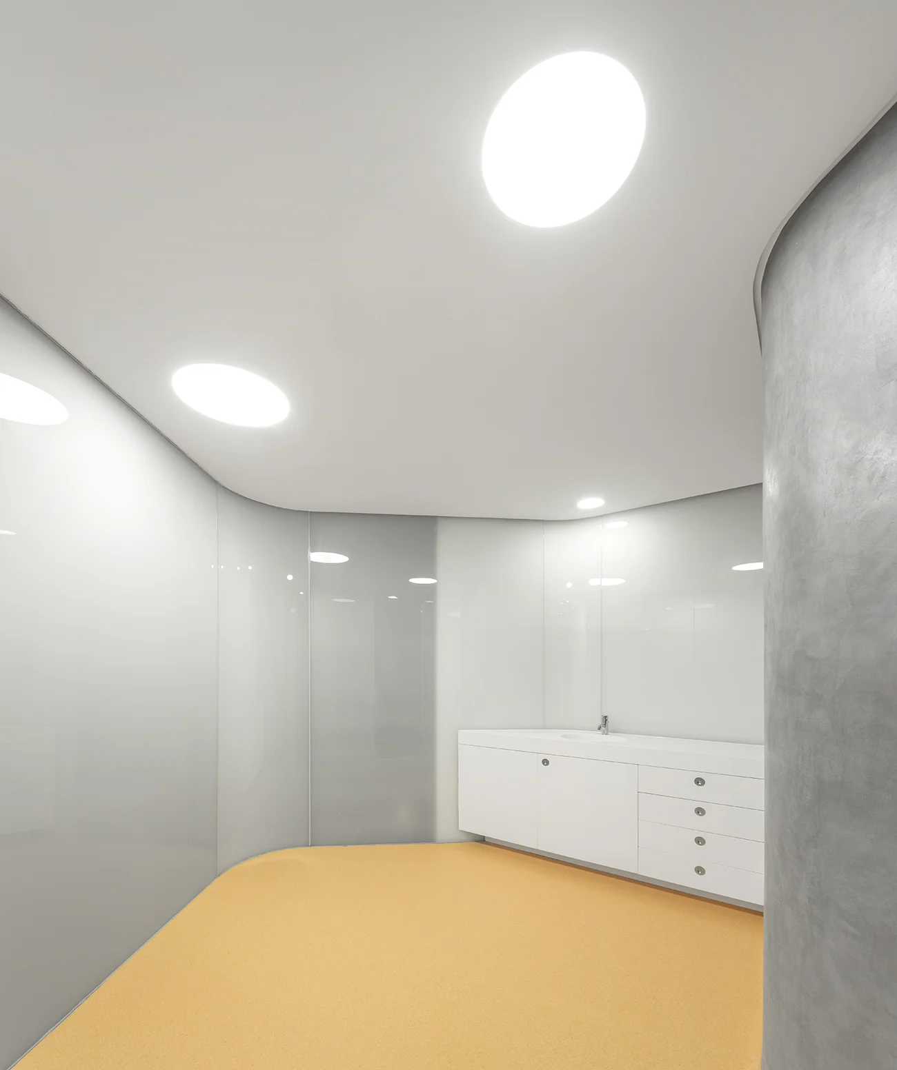Wood stairs, glossy white walls mixed with textured concrete at DRDERM office by Atelier Central
