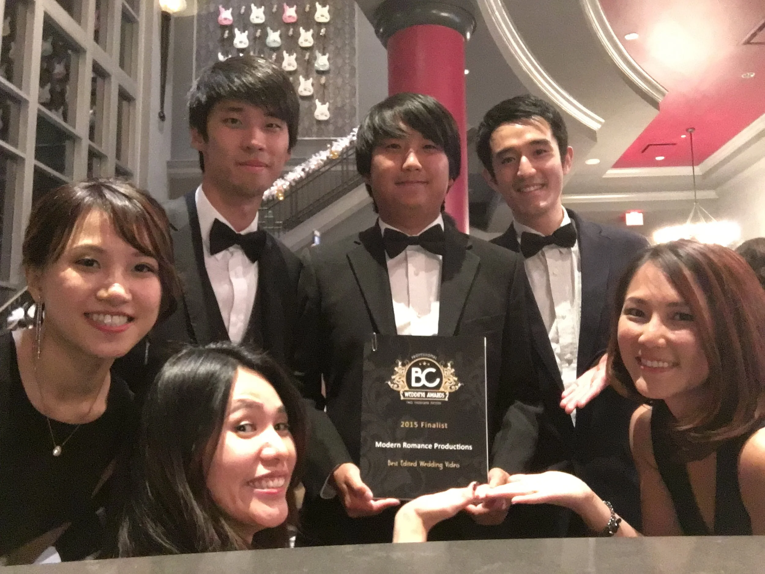 holding an award with 5 other people