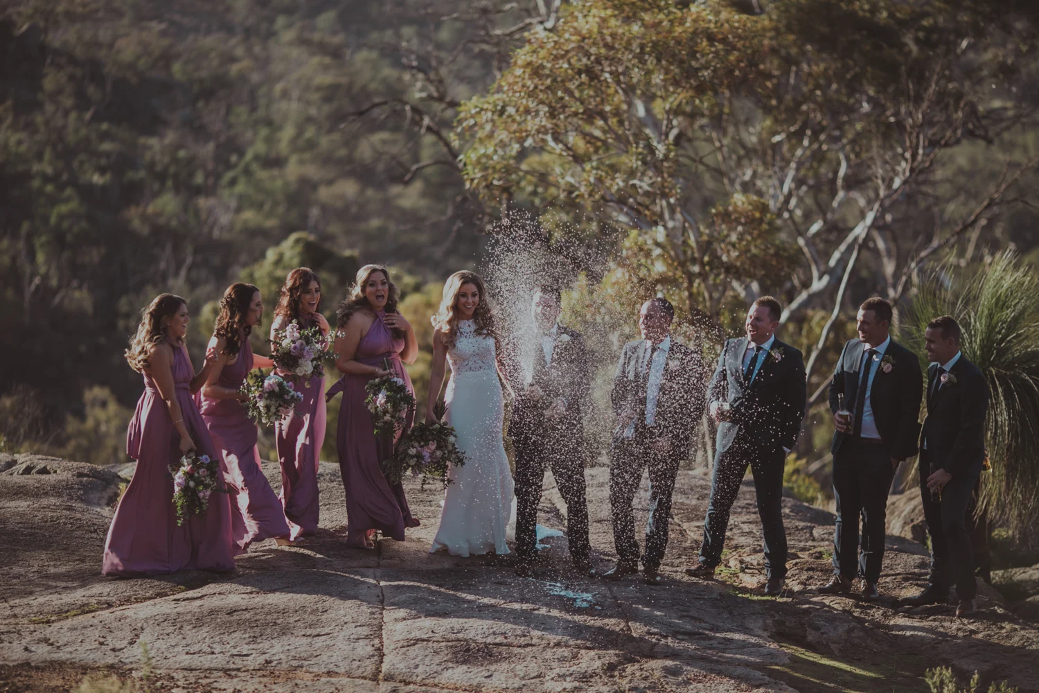 bridal party pops champagne