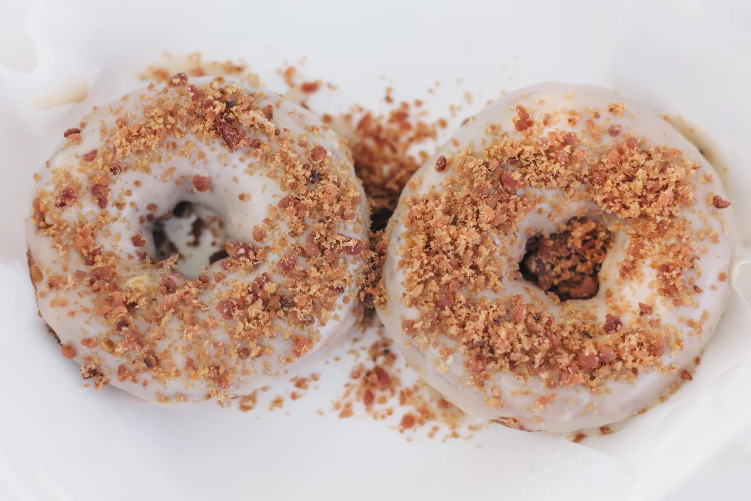 Duck Donuts in Duck, North Carolina. Maple Frosted Doughnut with Bacon served piping hot. 