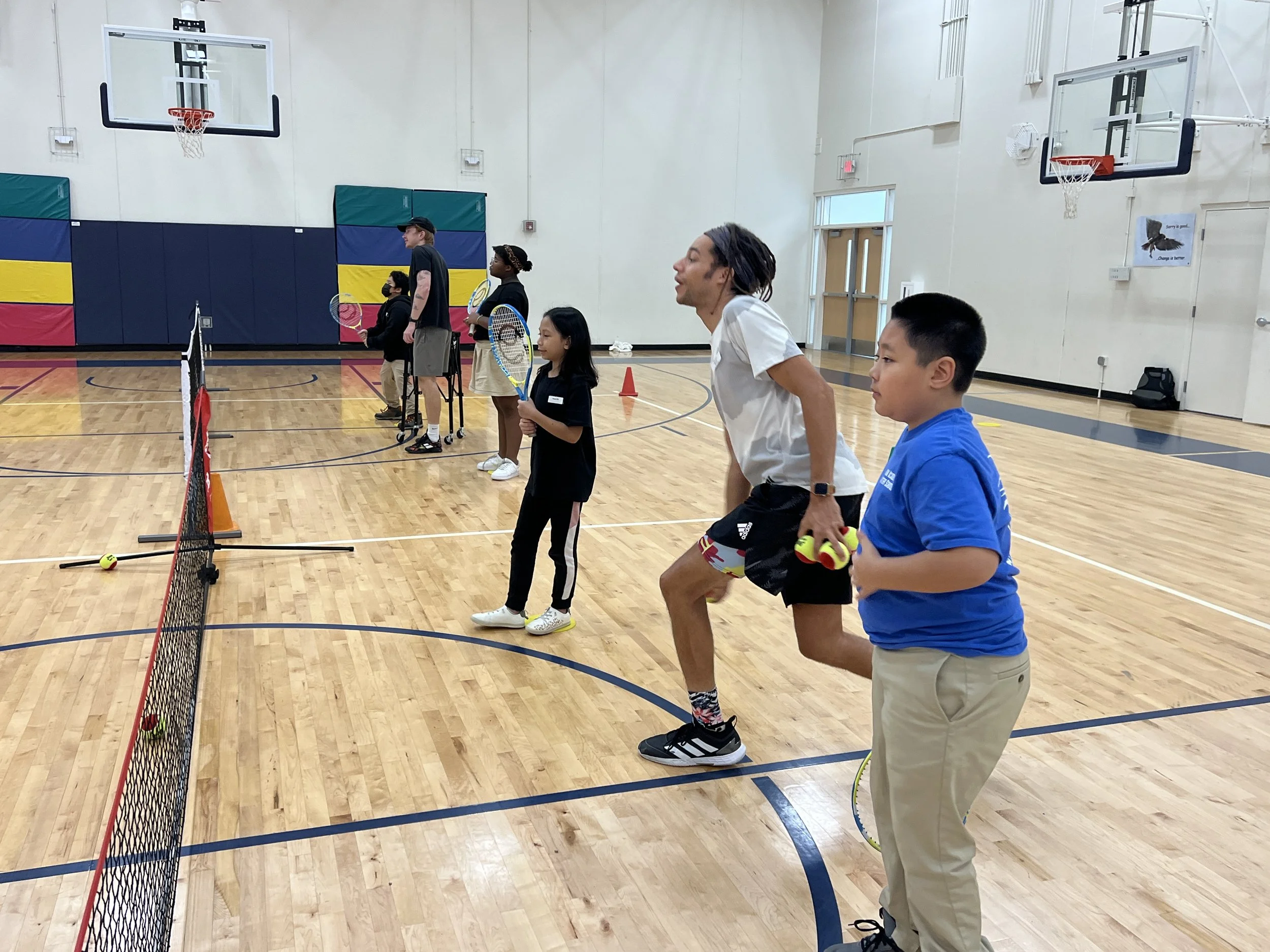 TennisWorks coach leading activities in a school gym
