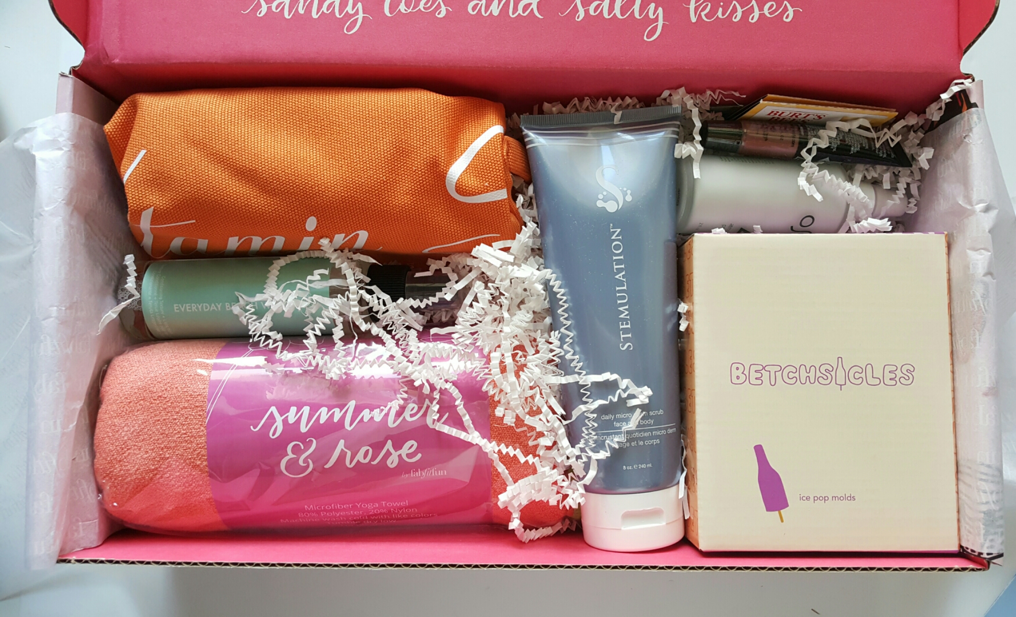 This is the summer 2016 box - clockwise from top left, you see: a beach bag, microderm body scrub (LOVED this stuff, nice lemony scent for summer), after sun face cream, Betchsicles silicone champagne-shaped popsicle molds, beach towel, sea spray hair product - and there was a layer under this! (!!!) 