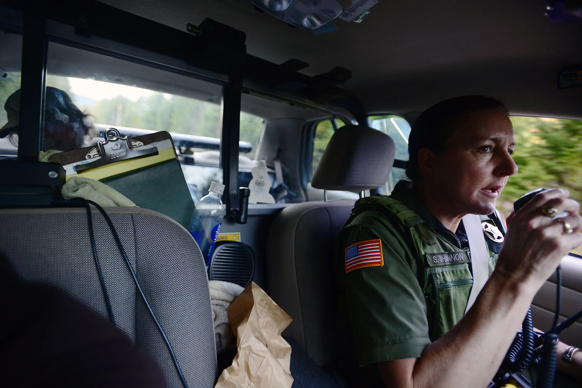  Lewis County Sheriff's Deputy Sue Shannon makes a call to dispatch as Richard Jacoby sits in the back seat of her patrol car as she drives away from Mineral. Jacoby, who was arrested for driving with a suspended license and possession of methampheta